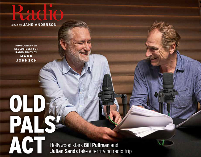 Actors Bill Pullman and Julian Sands share a laugh with a script and microphones in front of them, in a magazine feature